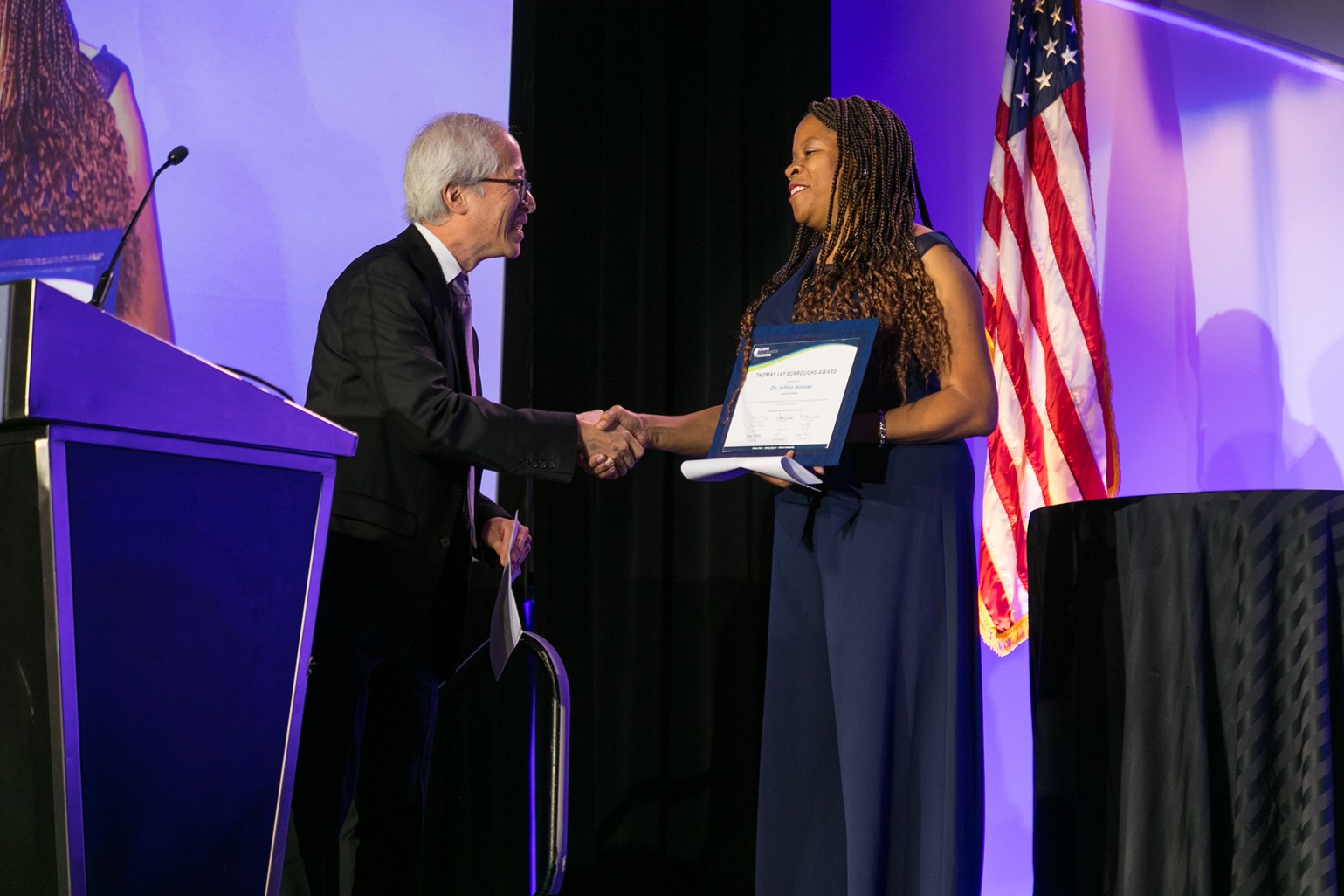 Dr. Isoye presents Dr. Hoover with Burroughs Award at the 2024 Joint Annual Conference